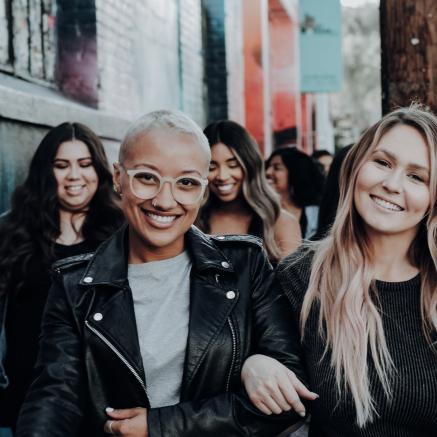 A group of friends walk down an alley together