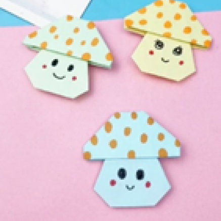 Paper craft of of origami folded mushrooms with polka dots