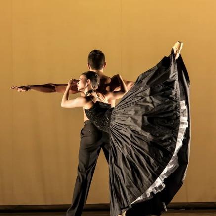 Ballet pair dance together in matching black outfits