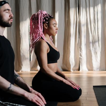 Picture of a man and a woman in a yoga class.