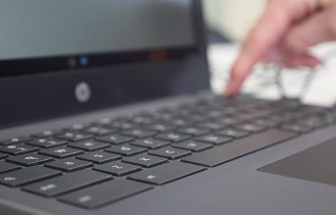 A student finds the power button on na Chromebook, during a Learning Lab class.