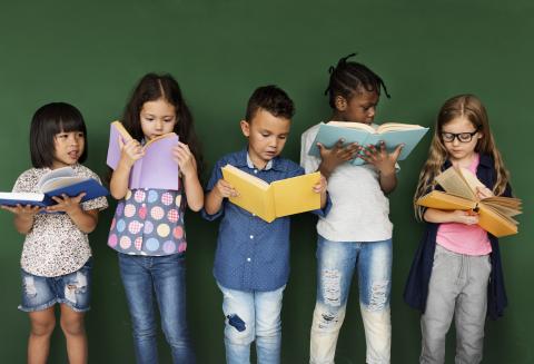 kids standing while reading books