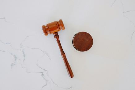 White marble counter with a light brown gavel laying on it