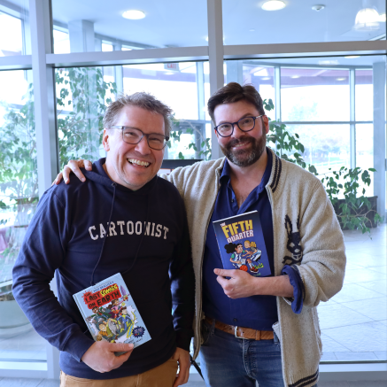 Mike Dawson and Jay Cooper pose together holding each other's books